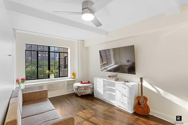 living area with beam ceiling, ceiling fan, and dark hardwood / wood-style flooring