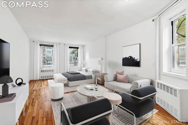 living room featuring hardwood / wood-style flooring and radiator