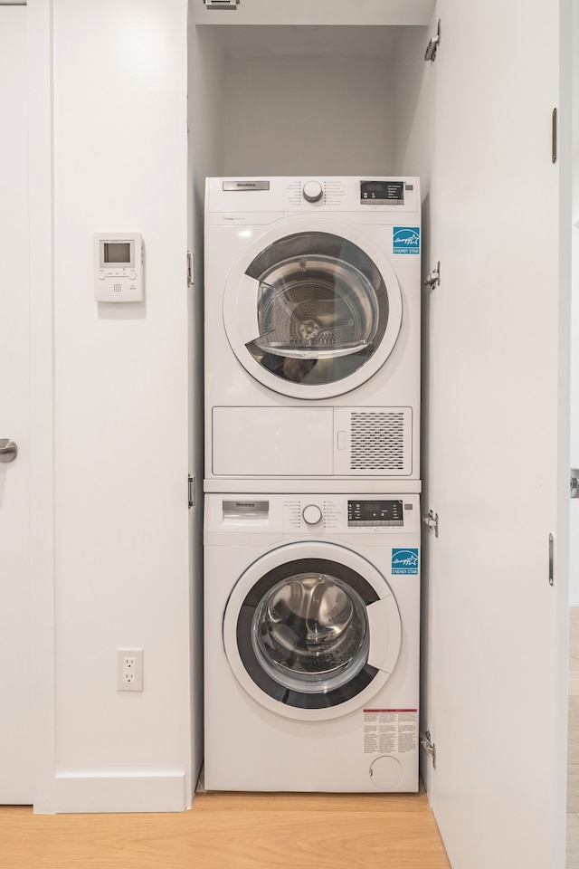 30-05 Vernon Blvd Unit 2-B, New York City, NY 11102 - laundry area featuring stacked washer and clothes dryer and wood finished floors