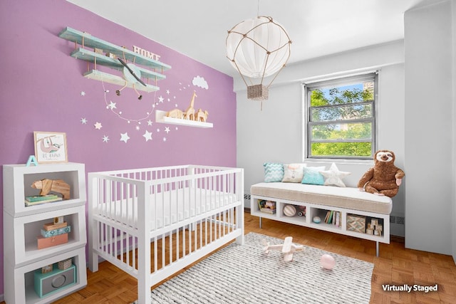 bedroom with parquet flooring and a chandelier