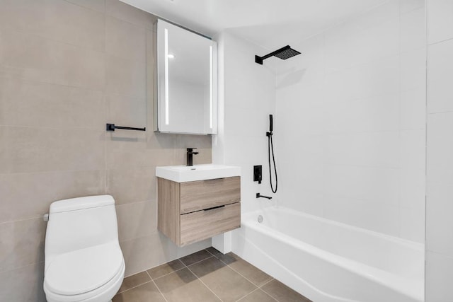 full bathroom with shower / bathing tub combination, tile walls, tile patterned flooring, vanity, and toilet