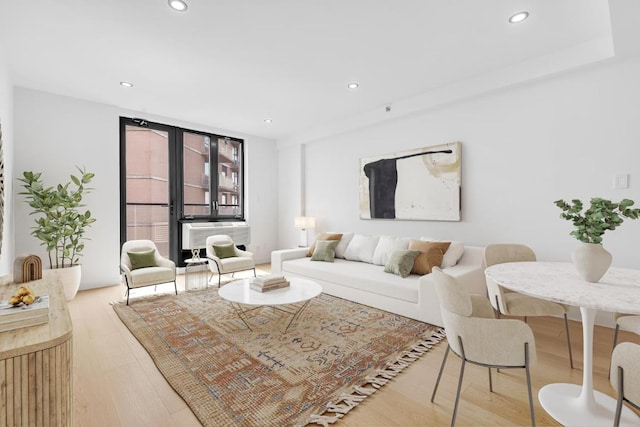 living room featuring cooling unit, light wood-style flooring, and recessed lighting