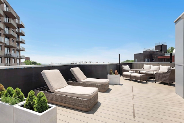 wooden terrace featuring outdoor lounge area