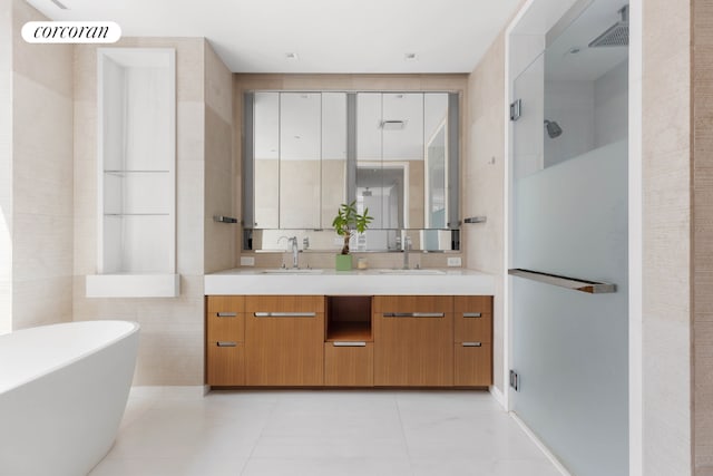 bathroom featuring shower with separate bathtub, tile walls, vanity, and tile patterned flooring