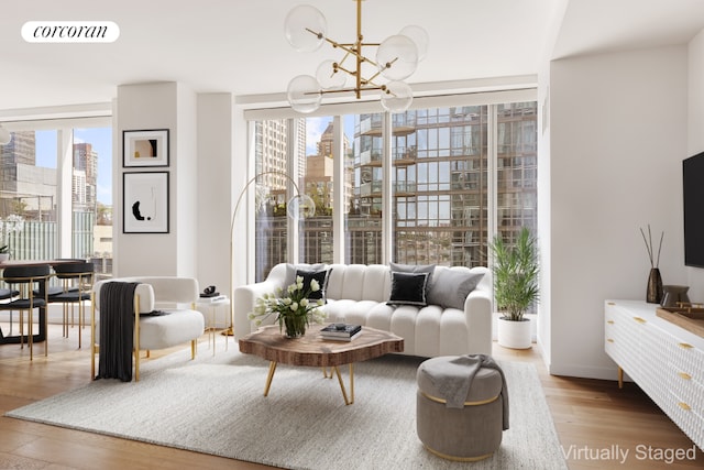 living area featuring floor to ceiling windows, hardwood / wood-style floors, and a notable chandelier