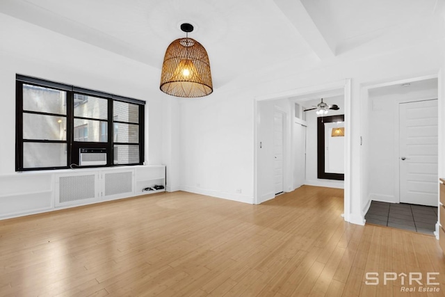 235 E 22nd St Unit 4M, New York City, NY 10010 - unfurnished room with light wood-type flooring, radiator, baseboards, and a chandelier
