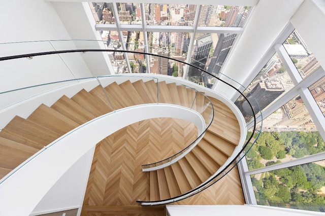 stairway featuring parquet floors