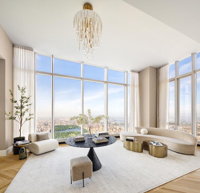 living room featuring parquet flooring, a chandelier, and a wall of windows