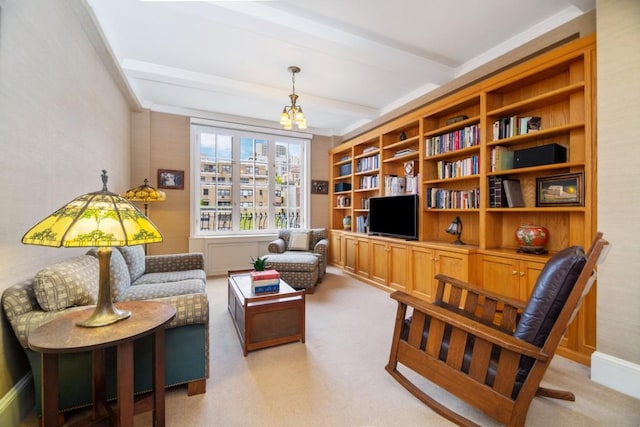 sitting room with beamed ceiling, crown molding, and light carpet