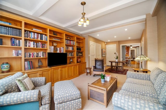 carpeted living room with beamed ceiling and a notable chandelier