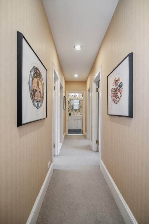 corridor with light colored carpet