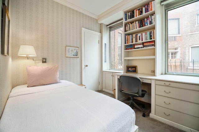 bedroom featuring carpet floors, crown molding, and built in desk