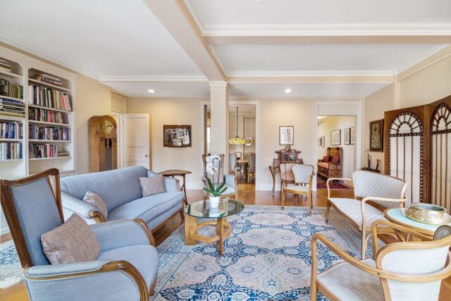 living room with ornate columns and hardwood / wood-style floors