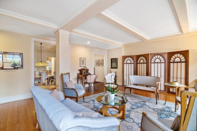 living room with wood-type flooring, beam ceiling, and decorative columns