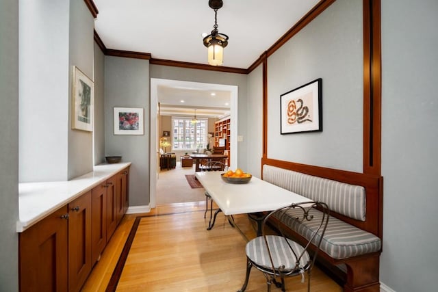 hallway featuring crown molding and light wood-type flooring