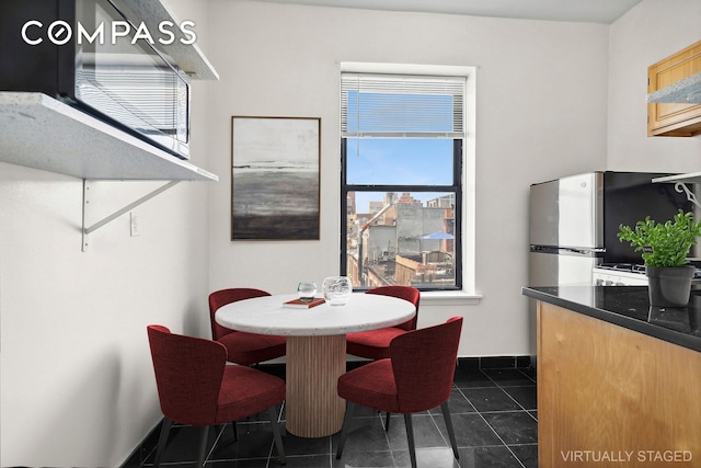 dining space with dark tile patterned floors