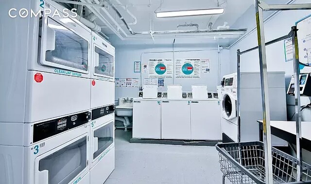 washroom with stacked washer and clothes dryer and washer and dryer