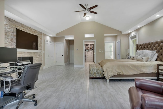 bedroom with baseboards, ensuite bath, light wood-style floors, and a ceiling fan