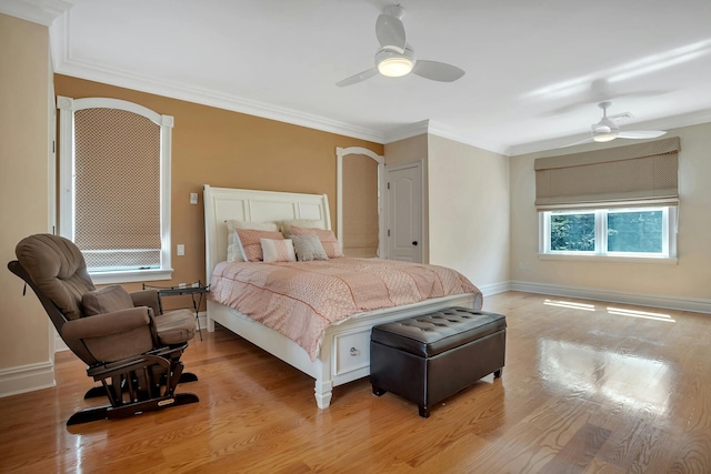 bedroom with light wood-style flooring, baseboards, and ornamental molding