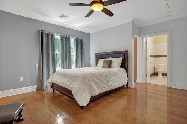 bedroom with attic access, crown molding, baseboards, and wood finished floors