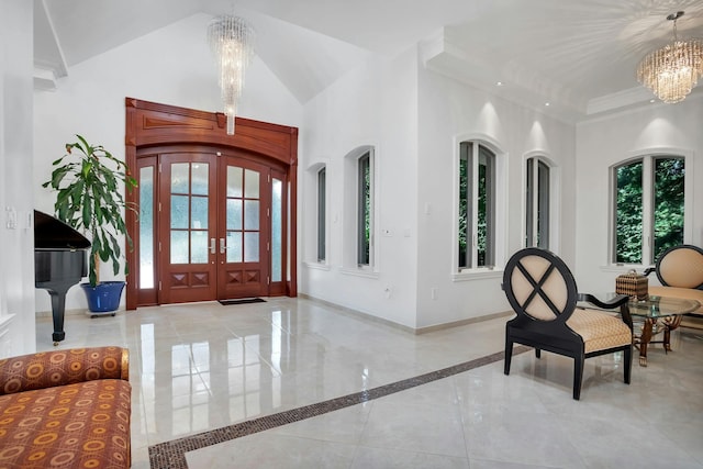 foyer entrance with high vaulted ceiling, french doors, arched walkways, an inviting chandelier, and baseboards