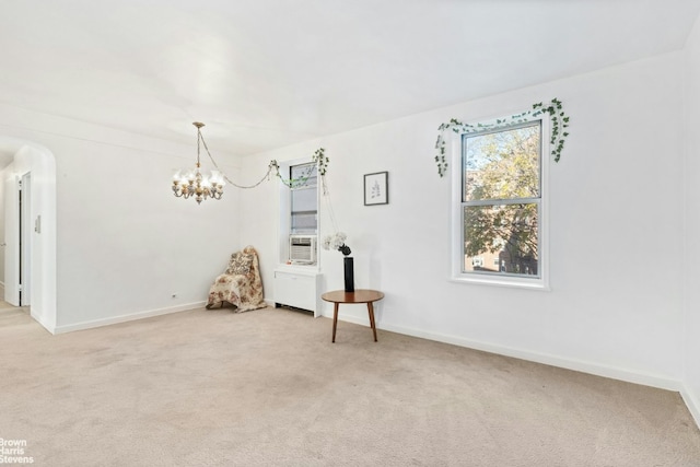 unfurnished room with cooling unit, an inviting chandelier, and carpet flooring