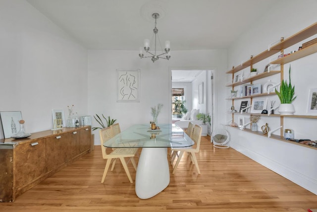 dining space featuring a chandelier and light wood-type flooring