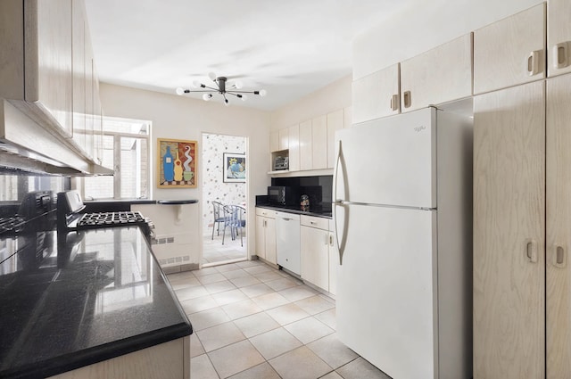 35 Sutton Pl Unit 11A, New York City, NY 10022 - kitchen featuring white appliances, light tile patterned floors, dark stone counters, and premium range hood