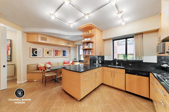 kitchen with light brown cabinets, dishwasher, kitchen peninsula, and sink