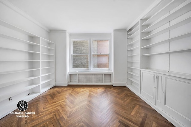 unfurnished room featuring crown molding and radiator heating unit