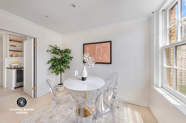 tiled dining area with ornamental molding and beverage cooler