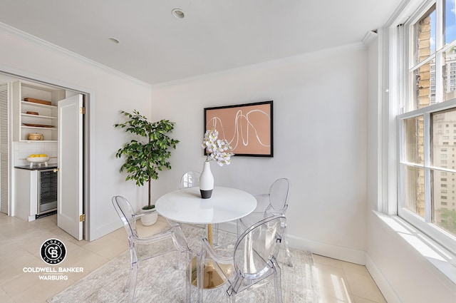 dining area with light tile patterned floors, plenty of natural light, and crown molding