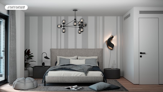 bedroom with a notable chandelier, wood finished floors, and visible vents