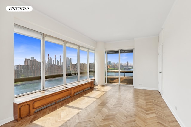 unfurnished sunroom with a view of city and visible vents