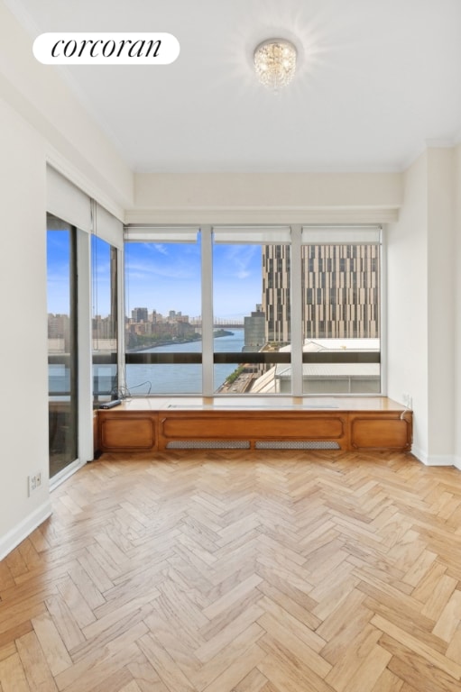 unfurnished sunroom with a water view