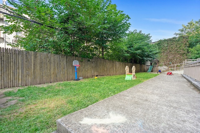 view of yard with a playground and a patio area