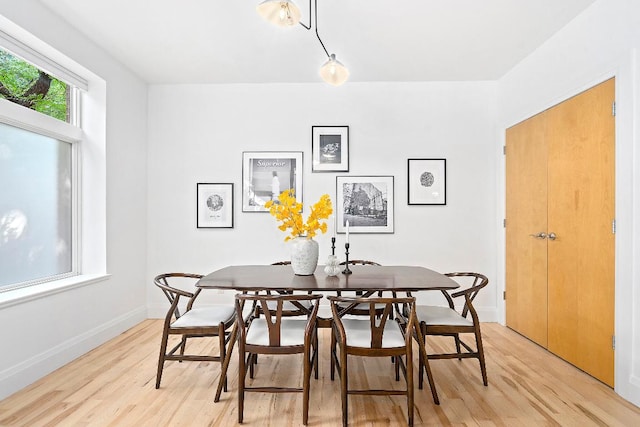 dining area featuring light wood-type flooring