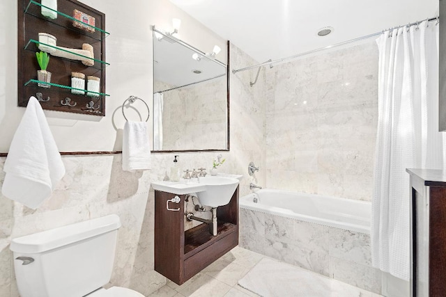 full bathroom with sink, tile walls, shower / bathtub combination with curtain, and toilet