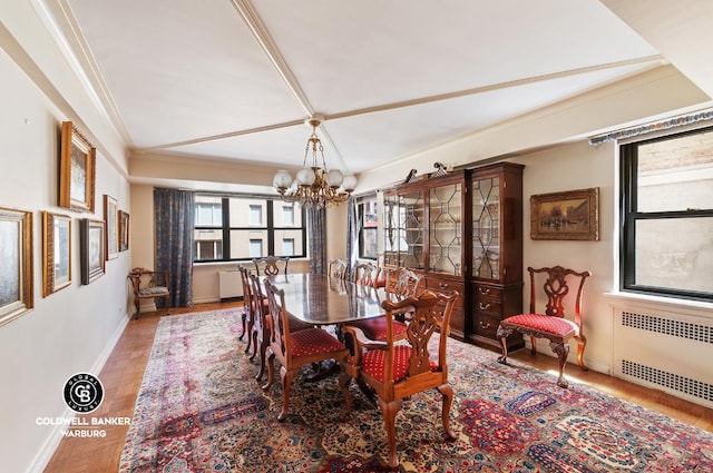 dining room featuring crown molding, parquet flooring, radiator heating unit, and a chandelier