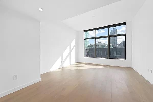 spare room featuring wood-type flooring