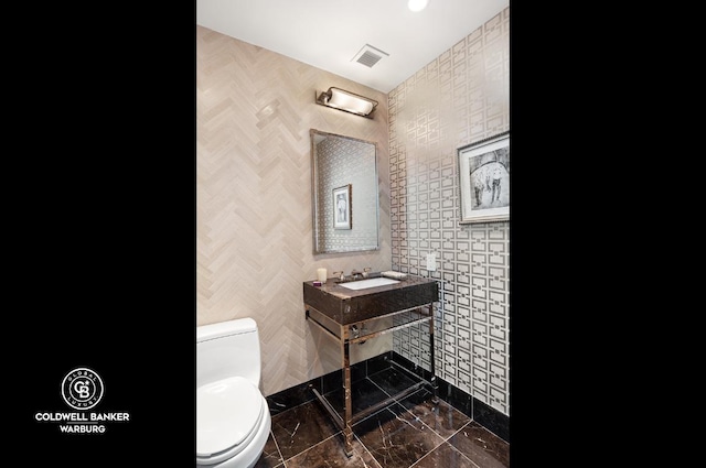 bathroom featuring sink and toilet