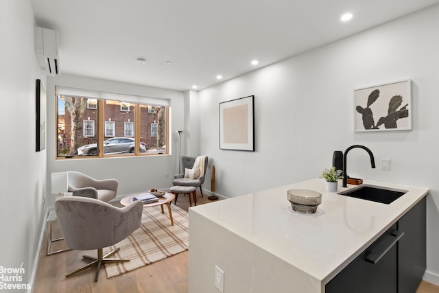 interior space featuring kitchen peninsula, sink, and light hardwood / wood-style flooring