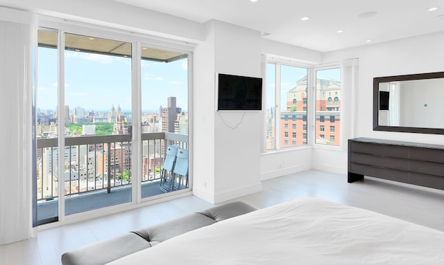 200 E 69th St Unit 31-A, New York City, NY 10021 - bedroom featuring access to exterior, wood finished floors, and recessed lighting