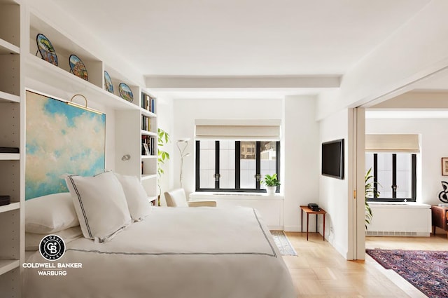 bedroom with light parquet floors