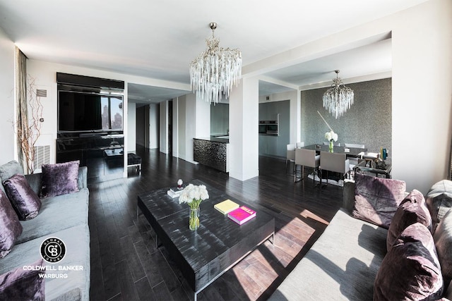 living room featuring dark wood-type flooring and an inviting chandelier