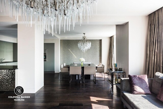 dining area featuring dark hardwood / wood-style flooring and a notable chandelier