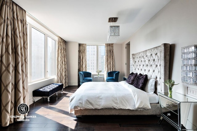 bedroom with hardwood / wood-style floors and multiple windows