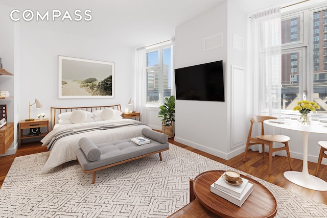 bedroom featuring wood finished floors and baseboards