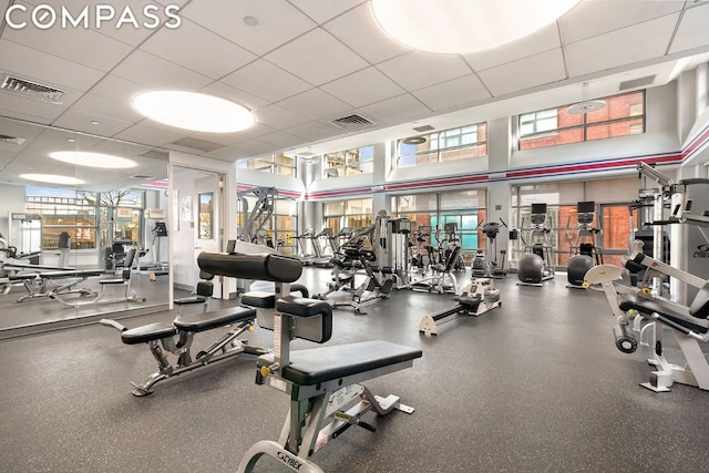 workout area featuring a paneled ceiling