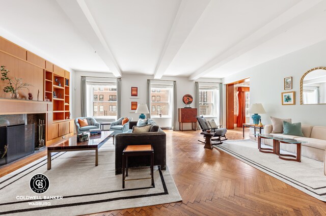 living room with parquet floors, beam ceiling, and a premium fireplace